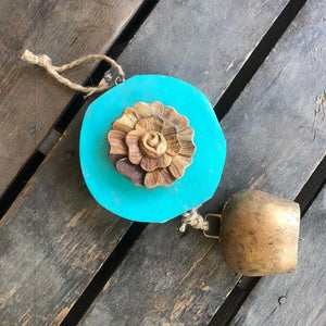 Carved  wood rose on Teal log