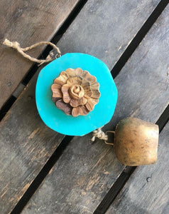 Carved  wood rose on Teal log